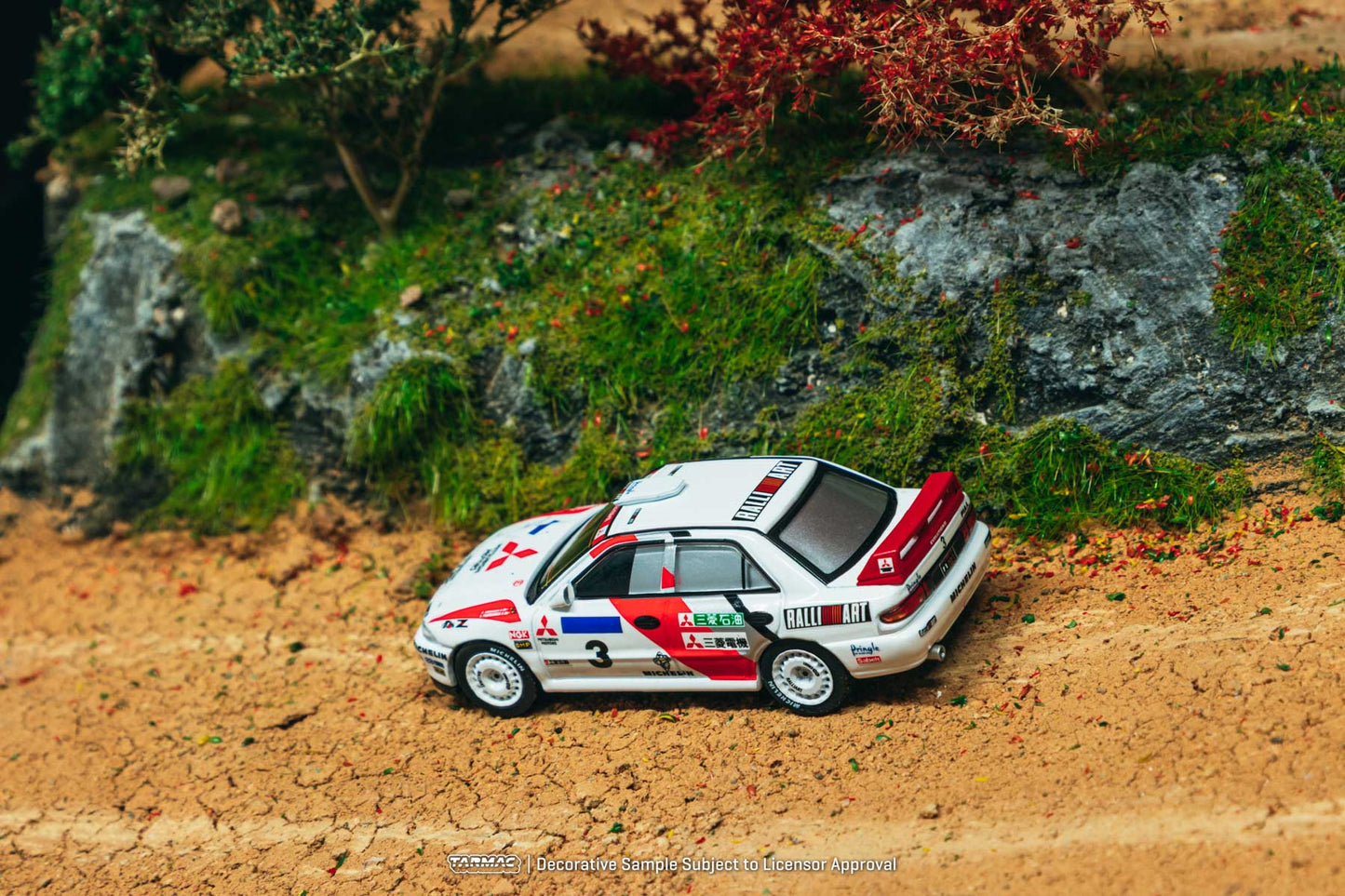 Model car on a miniature landscape with rocks and grass
