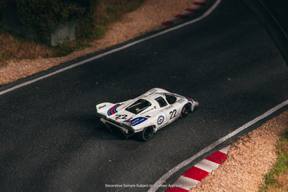 Model race car on a miniature track with a checkered flag in the background