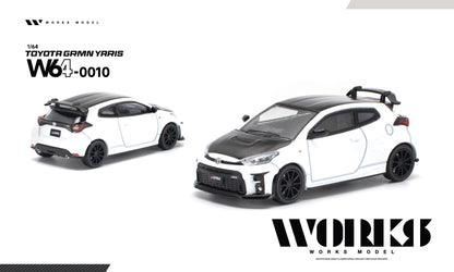 A 1/64 scale diecast model car of a white and black Toyota Gamin Yaris W640010, shown from both front-three-quarter and rear-three-quarter angles on a clean white background with WORKS MODEL branding.