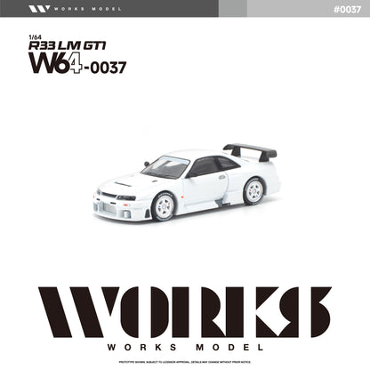 Front three-quarter view of the Works Model 1:64 Nissan Skyline GT-R R33 LM GT1 in factory white with white wheels, aerodynamic widebody, vented hood, large rear wing, and race-inspired styling. Product code W64-0037. Prototype diecast model on a white background.