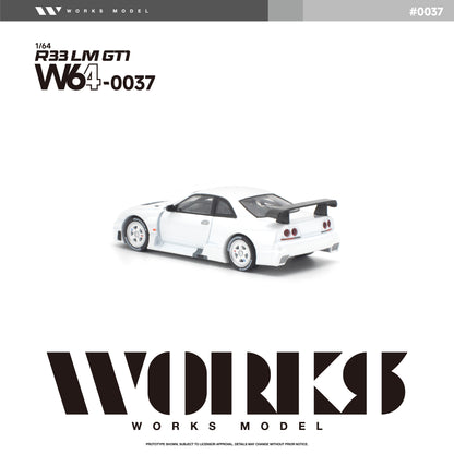 Rear three-quarter view of the Works Model 1:64 Nissan Skyline GT-R R33 LM GT1 in factory white with white wheels, aerodynamic widebody, rear diffuser, and large GT-style rear wing. Product code W64-0037. Prototype diecast model on a white background.
