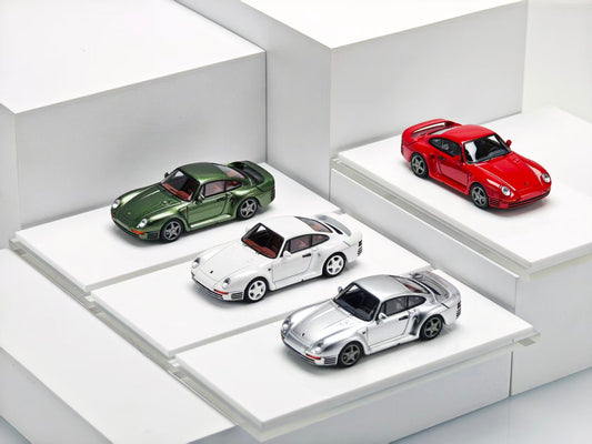 Four model cars displayed on a white platform with a white background