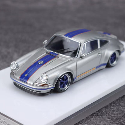 Model car with blue stripes on a gray background