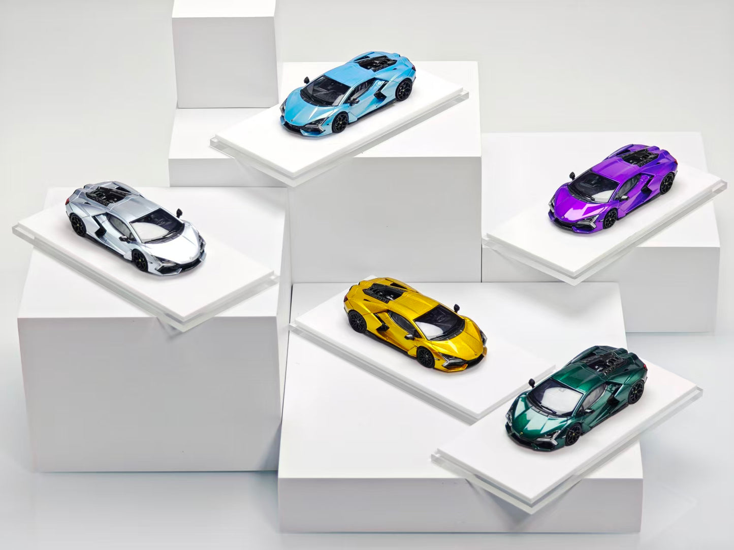 Five toy cars on white stands against a light gray background