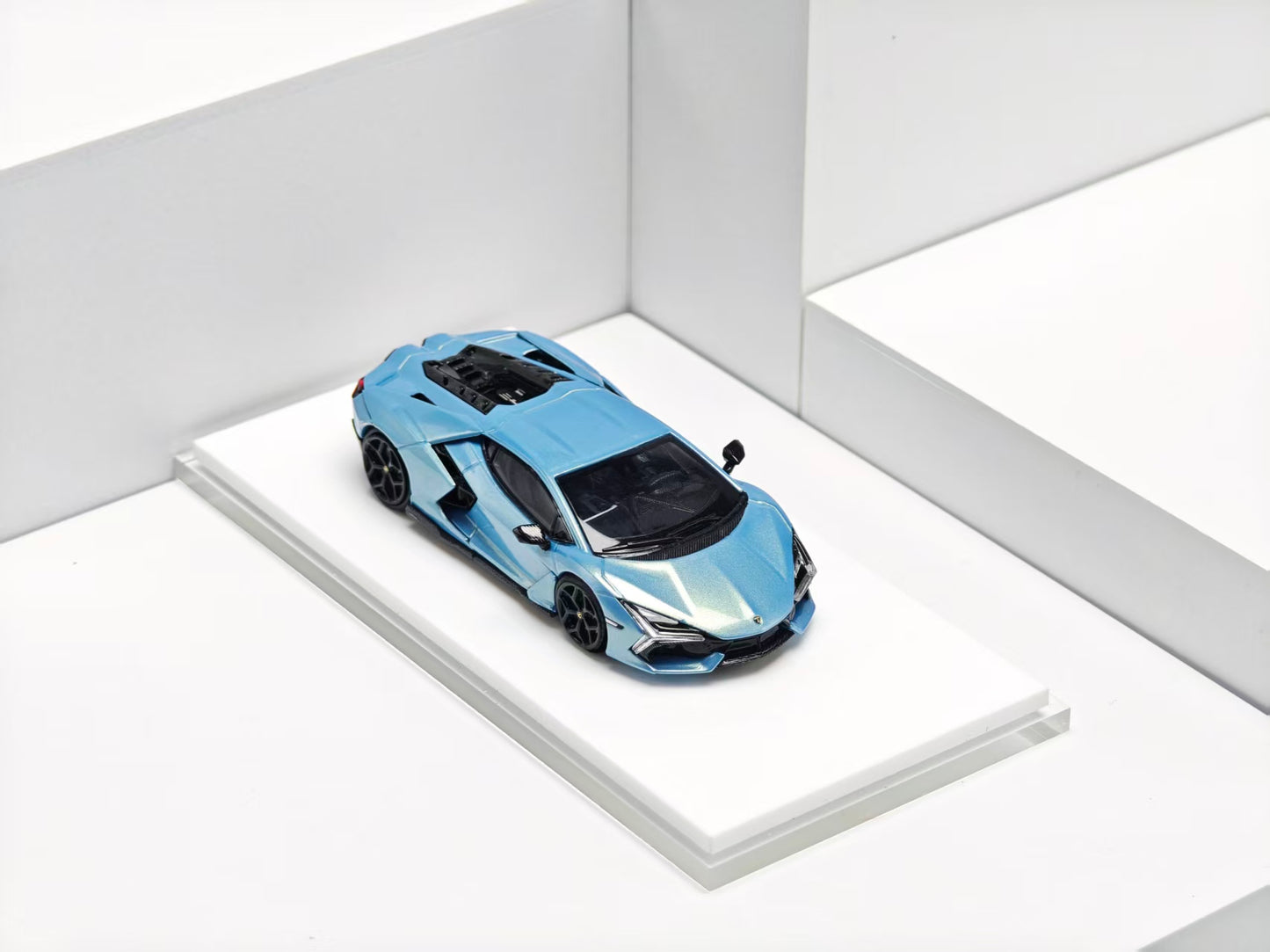 Blue sports car model on a white platform with a white background
