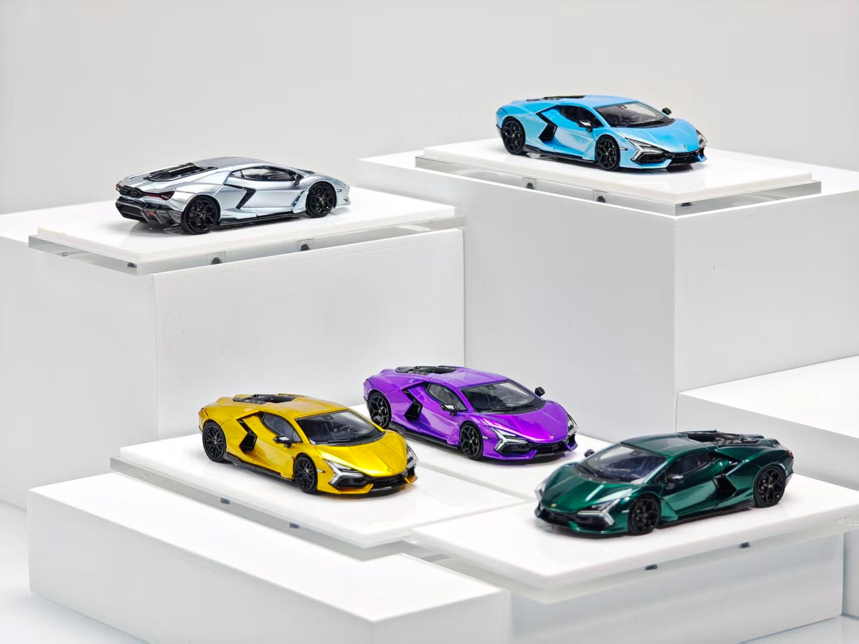 Collection of colorful model cars on a white platform