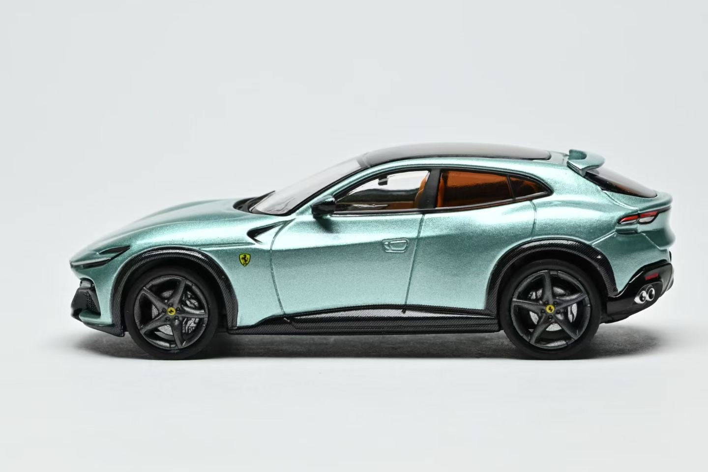 Luxury SUV with Ferrari logo on a light gray background