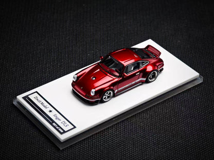 Red model car on a display stand with a dark background