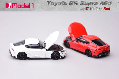 Two toy cars, one white and one red, with open hoods on a gray background.