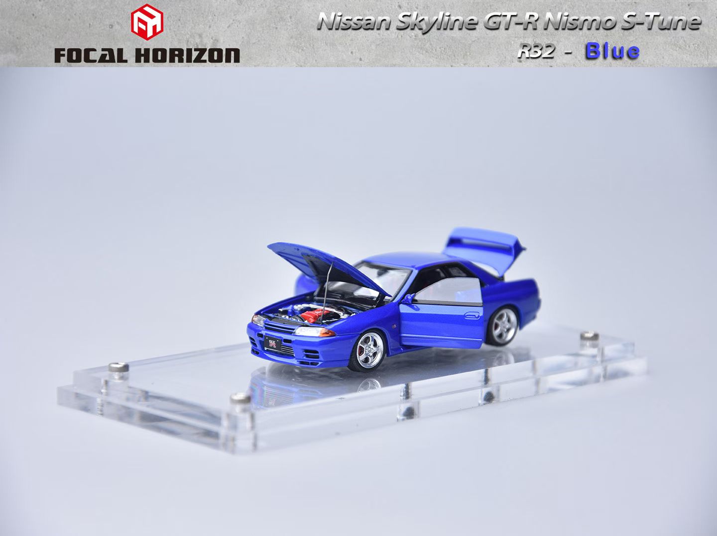 Model of a blue Nissan Skyline GT-R Nismo S-Tune on a clear stand with 'Focal Horizon' branding.