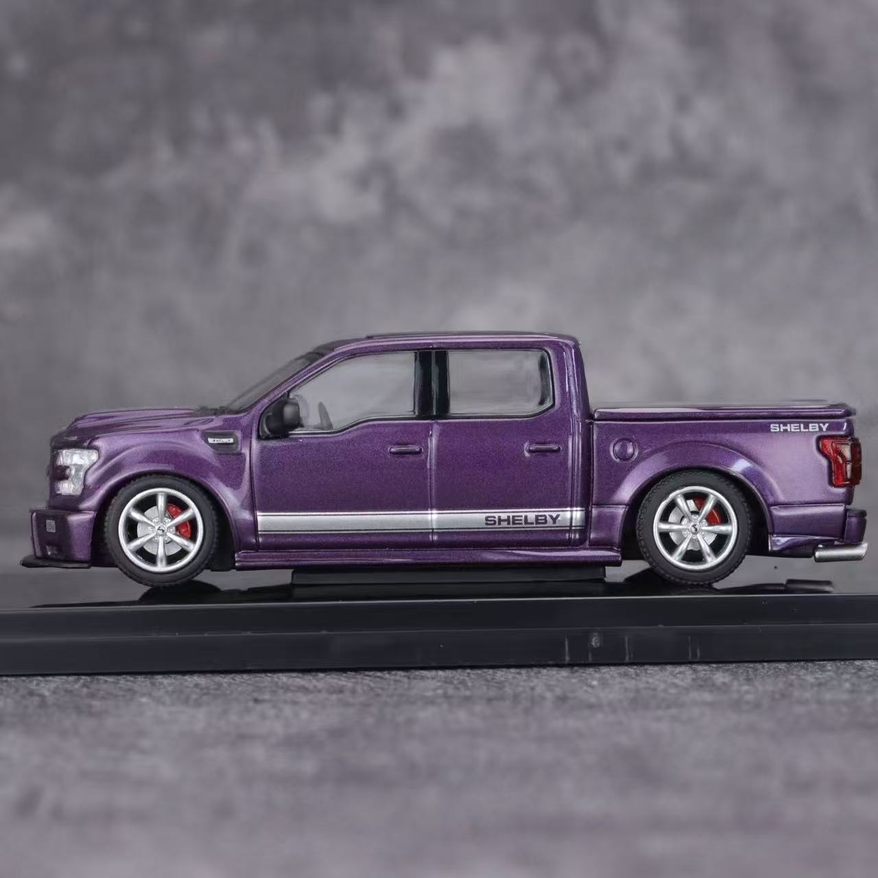 Model of a purple Shelby truck on a gray background
