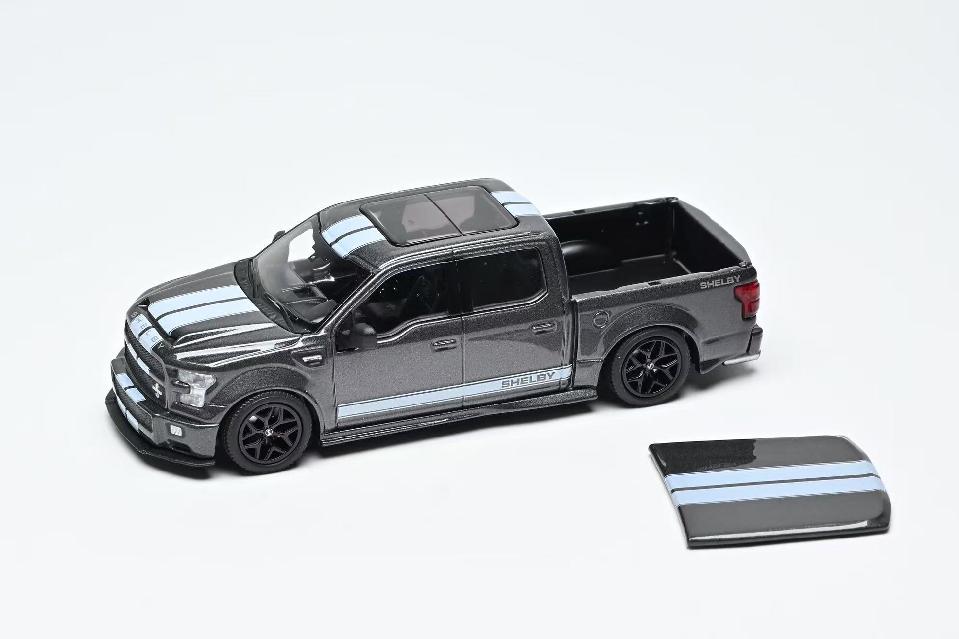 Model truck with a smaller truck model on a white background