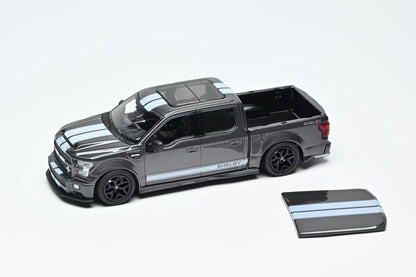 Model truck with a smaller truck model on a white background