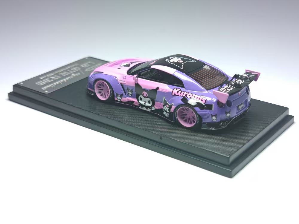 Model car with pink and black design on a gray platform
