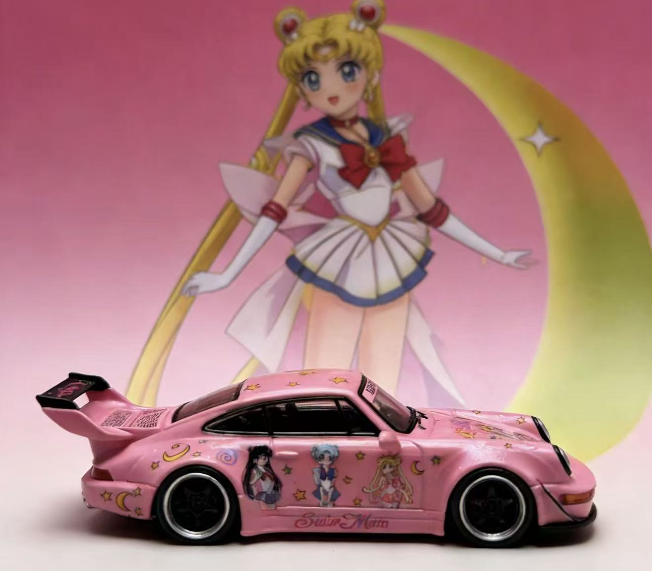 Pink toy car with character designs in front of an animated character with a pink background