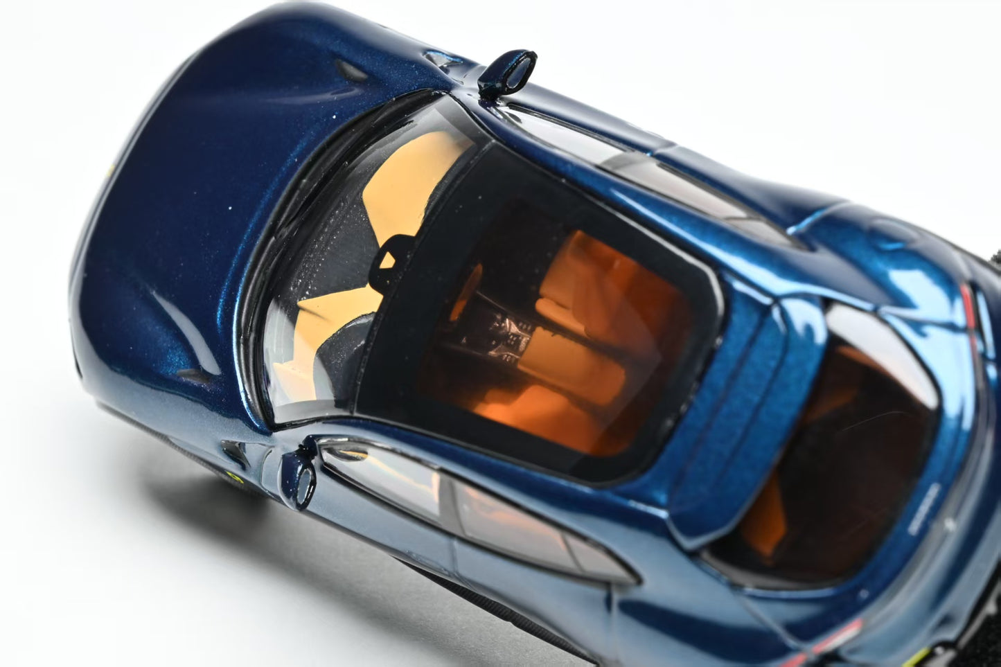 Close-up of a blue car model with a clear canopy on a white background