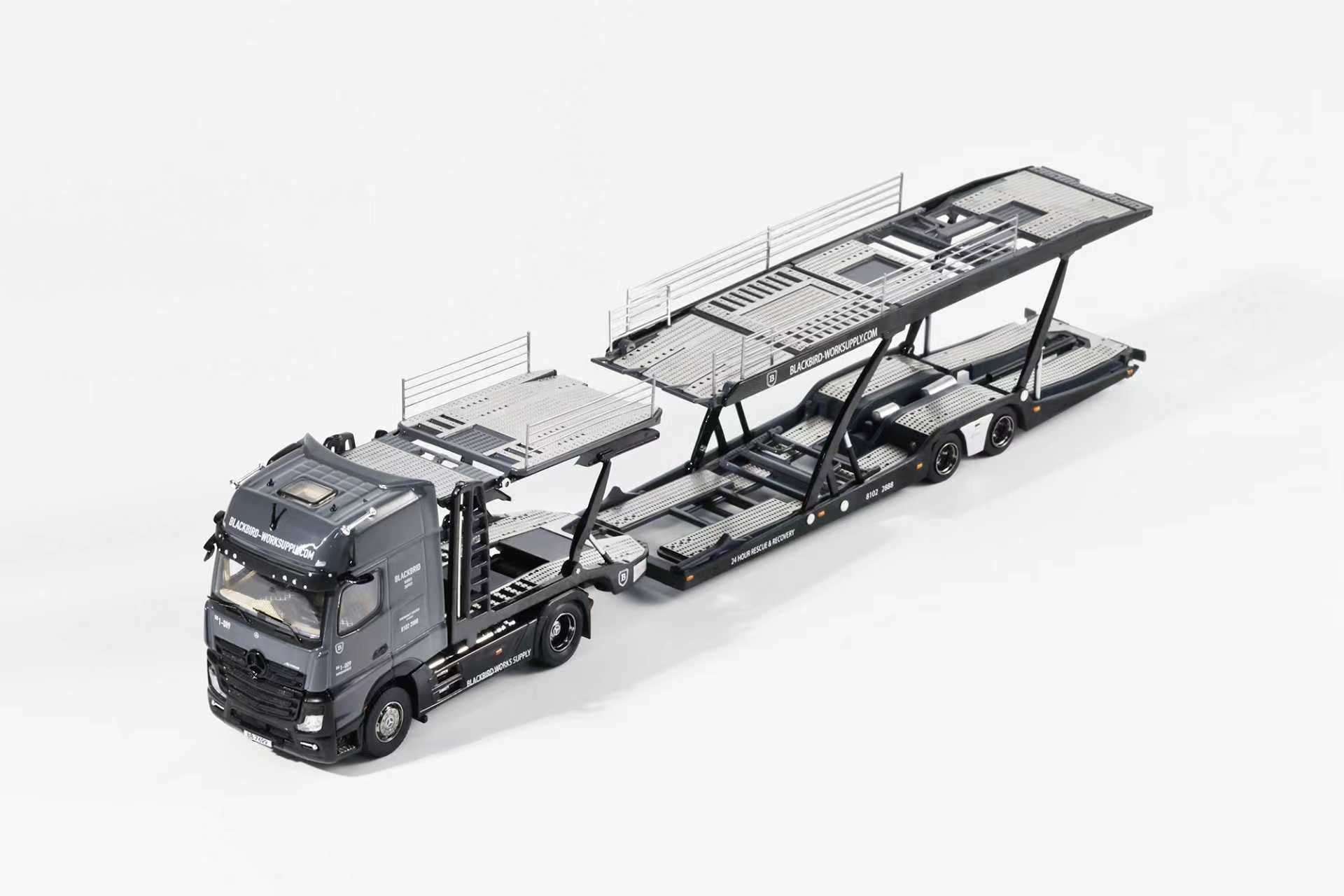 Model of a truck with a car carrier on a white background