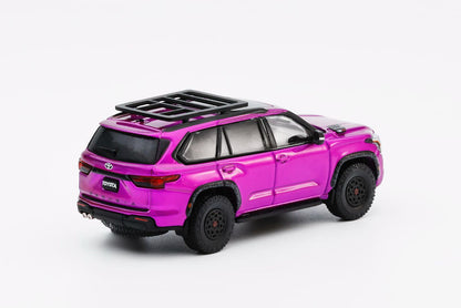 Pink toy SUV with black roof rack on a white background