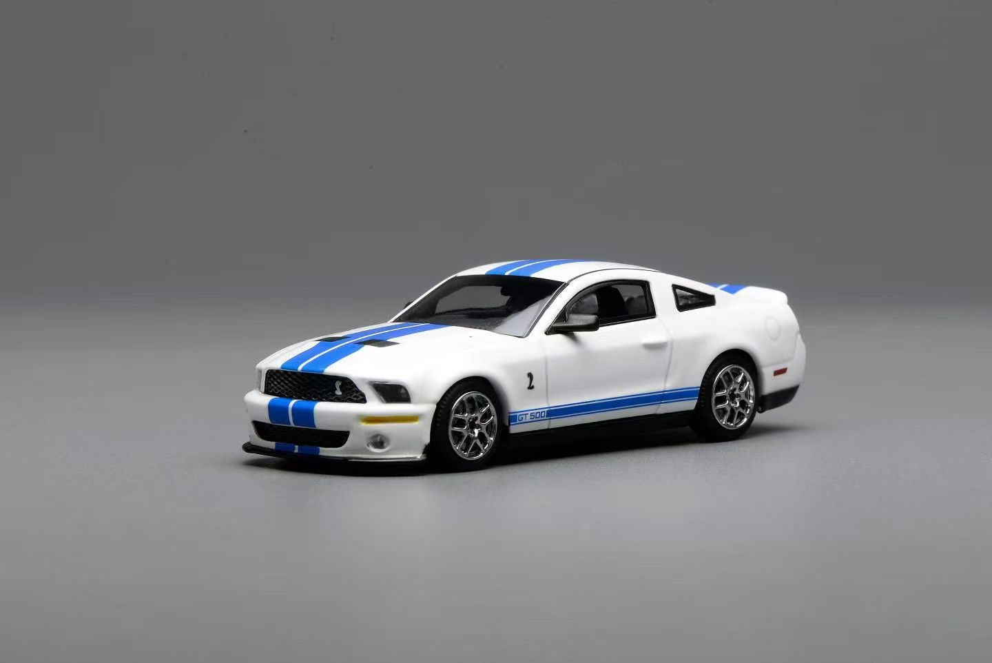 White model car with blue stripes on a gray background