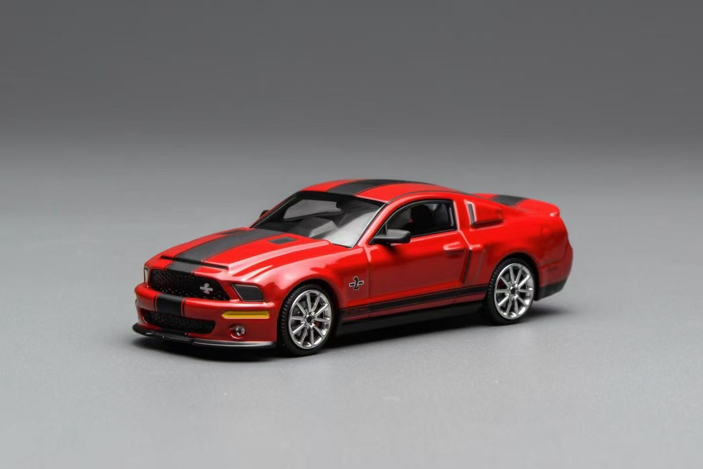 Red and black model car on a gray background