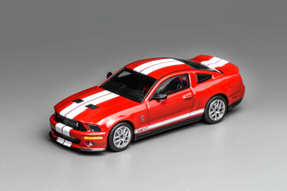 Red Ford Mustang GT500 and white model car on a gray background