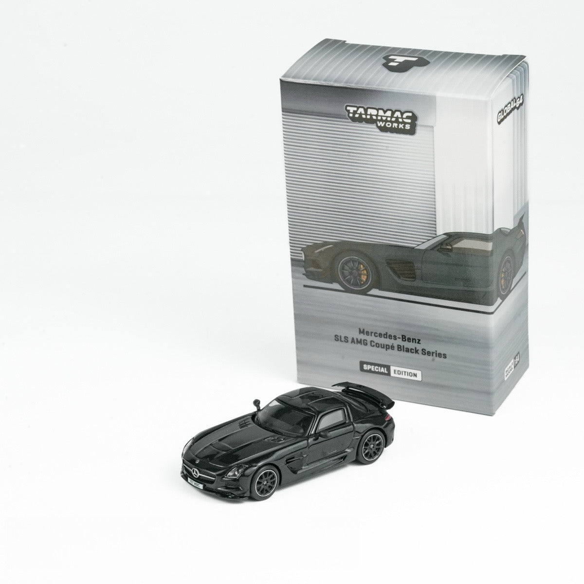 Model of a Mercedes-Benz SLS AMG Coupé in black with packaging on a white background. The box shows the car's image and reads "Special Edition."